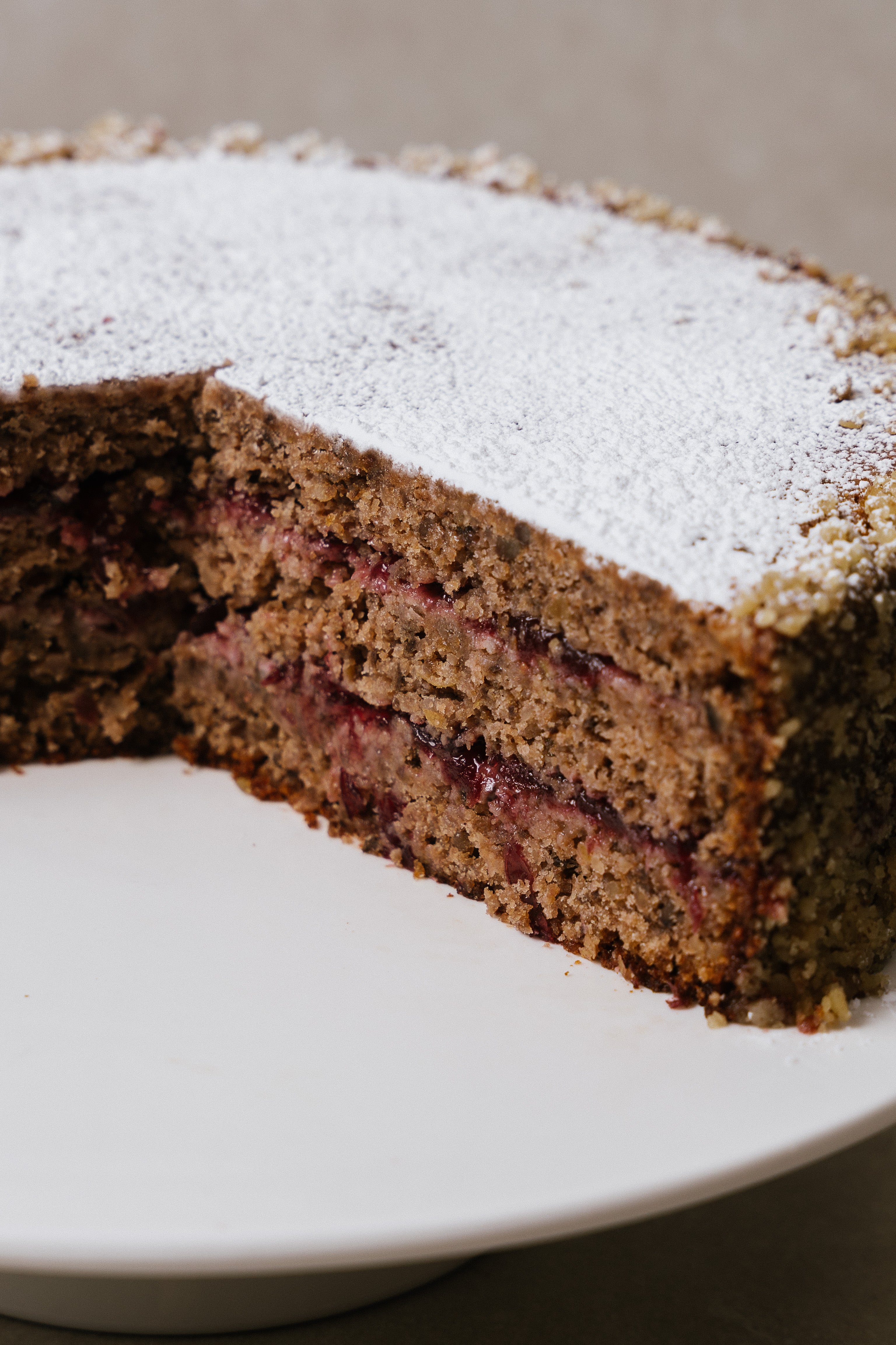Top view of Austrian buckwheat lingonberry cake on cake stand
